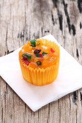Mix fruit cupcakes on white paper.
