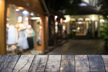 Empty wooden table and booked at hotel in night.