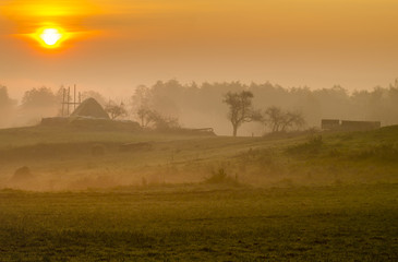 Fototapeta premium Piękny,mglisty wschód słońca nad wiejską łąką 