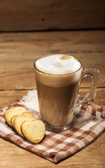 Glass cup with coffee and cookies in a heart shape