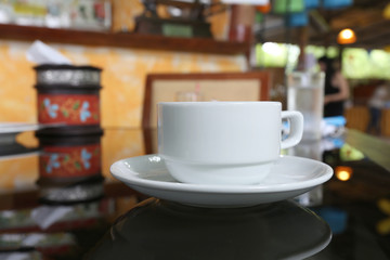 White coffee cup placed on the foods table.