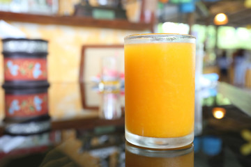 Glass of orange juice placed on the foods table.