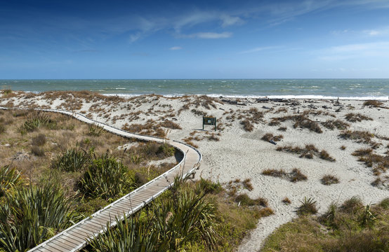 Wooden walkway by the beach at Tauparikaka Marine Reserve, Haast, New Zealand