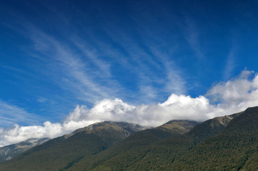 Obraz na płótnie Canvas Cloudy blue sky and mountains in Otago region, south island of New Zealand