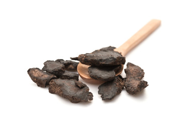 chinese herb on a wooden spoon on white