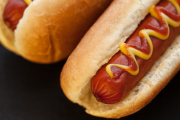 Barbecue Grilled Hot Dog with Yellow Mustard and ketchup on wooden table. Fast food.