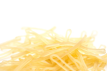 lots of elastic bands on white background with copy space