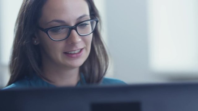 Portrait of Young Woman Looking at Computer Screen. Shot on RED Cinema Camera in 4K (UHD).