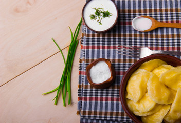 Vareniks  with sour cream and dill - national ukrainian cuisine.