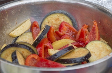 Chopped vegetables in a bowl. Zucchini, eggplant, bell peppers, tomatoes.