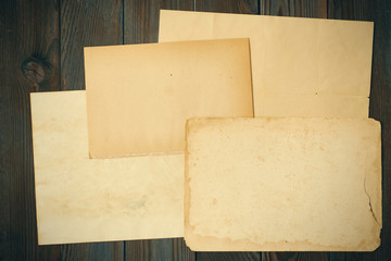 Vintage paper on textured old wooden background