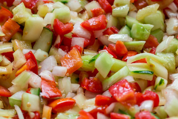 Vegetable salad of fresh sliced tomatoes, onions, peppers, cucum