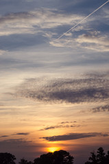 Bright orange and yellow colors sunset sky. sunset with a line by the plane.