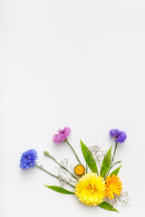 Frame with flowers on white background. Top view, flat lay