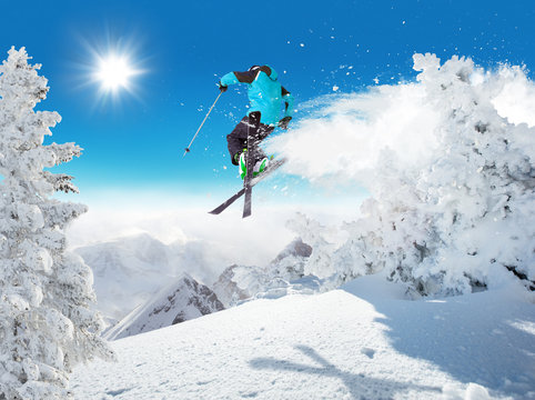 Skier at jump in Alpine mountains
