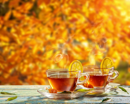 Autumn still life with tea cups on wooden planks