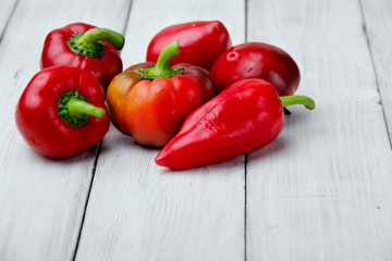 mini colored sweet peppers on a wooden background