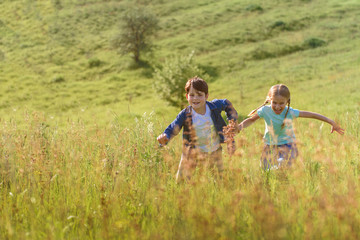 Boy and girl running on field