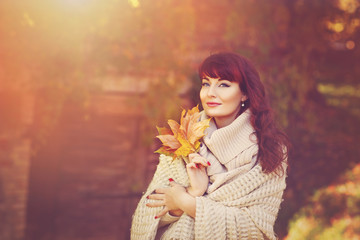 Beautiful girl outdoors with autumn leaves