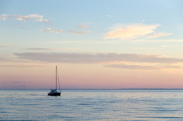Fototapeta premium Single sailboat in calm water