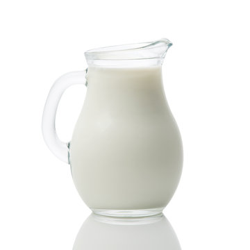 Glass jug of fresh milk isolated on white background