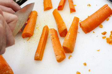 Man cutting carrot batons