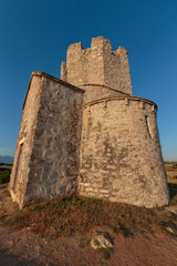 Naklejka premium Old small stone church of St. Nicholas on hill near city of Nin in Croatia. Golden hour.
