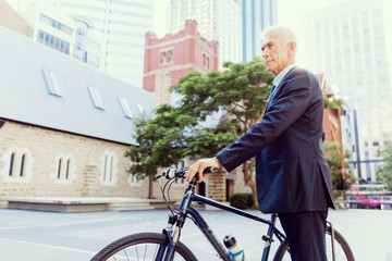 Fototapeta premium Successful businessman riding bicycle