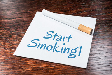 Start Smoking Reminder With Cigarette On Wooden Shelf