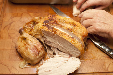 Whole roast chicken sliced through the breast