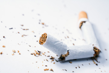 Broken Cigarette With Tobacco Pieces In White Box