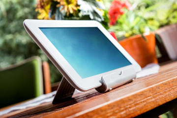 White Business Tablet On Wooden Table In Relaxing Atmosphere