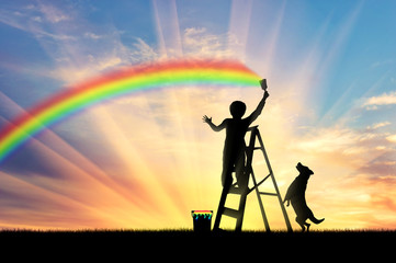 Child paints a rainbow in the sky
