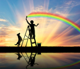 Child paints a rainbow in the sky