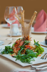 Fresh salad with seafood, fried shrimp and arugula in the restaurant