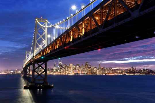 San Francisco skyline framed by the Bay Bridge at sunset
