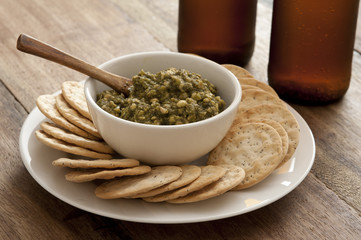 Plate full of dip and bowl of chips
