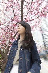 若い女性　ポートレート　外　春　桜　上半身　カジュアル　見上げる　新宿　