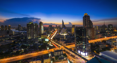 Fototapeta na wymiar Bangkok Transportation at Dusk with Modern Business Building along the river (Thailand)