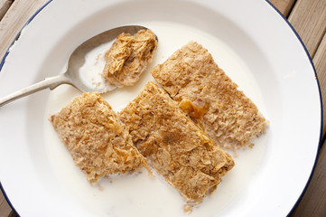 View from above of spoon in wheat bar cereal