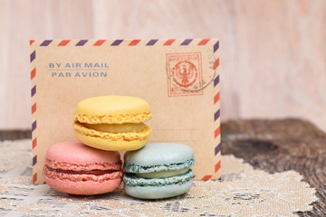 Macaron cookies in front of vintage envelope