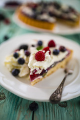 Delicious sponge cake with jelly and with fresh forest fruit with whipped cream and mascarpone.