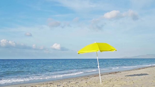 yellow parasol by the shore in cinemagraph effect