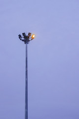 Security lights on top of a tall steel mast