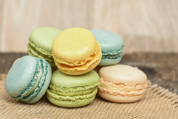 Macarons piled on burlap napkin in rustic setting
