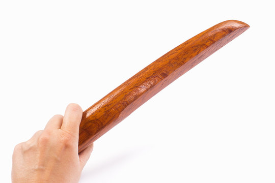 hand holds wooden tanto