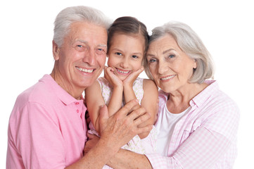 Grandparents with granddaughter on white