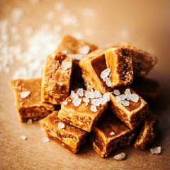 Caramel candies over dark  background.Golden Butterscotch toffee