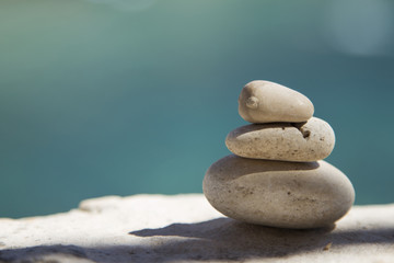 Balance and harmony concept. Stones and rocks balance on the bea