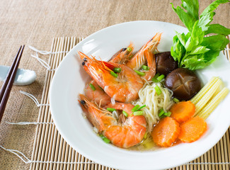 Yellow noodles soup with shrimp on bamboo mat, Chinese food